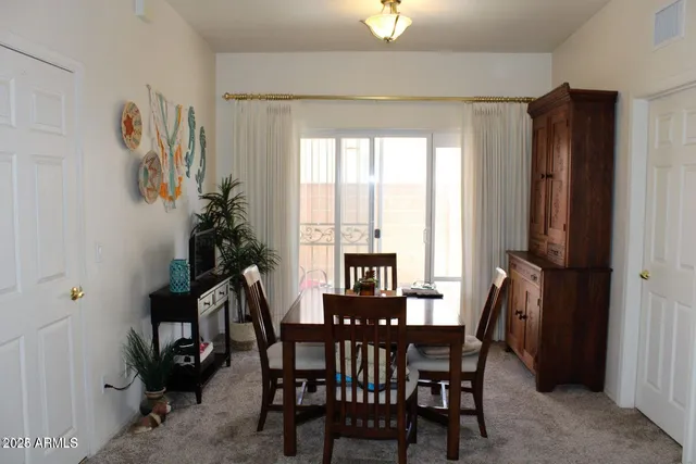a view of a dining room with furniture and a window