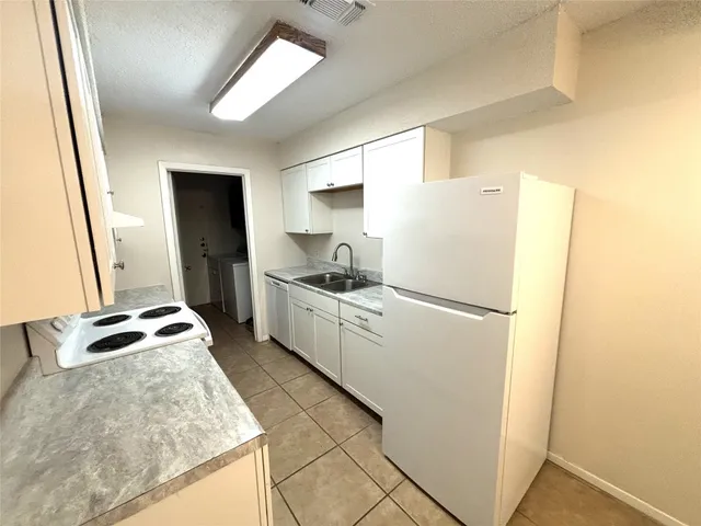 a kitchen with a refrigerator sink and stove
