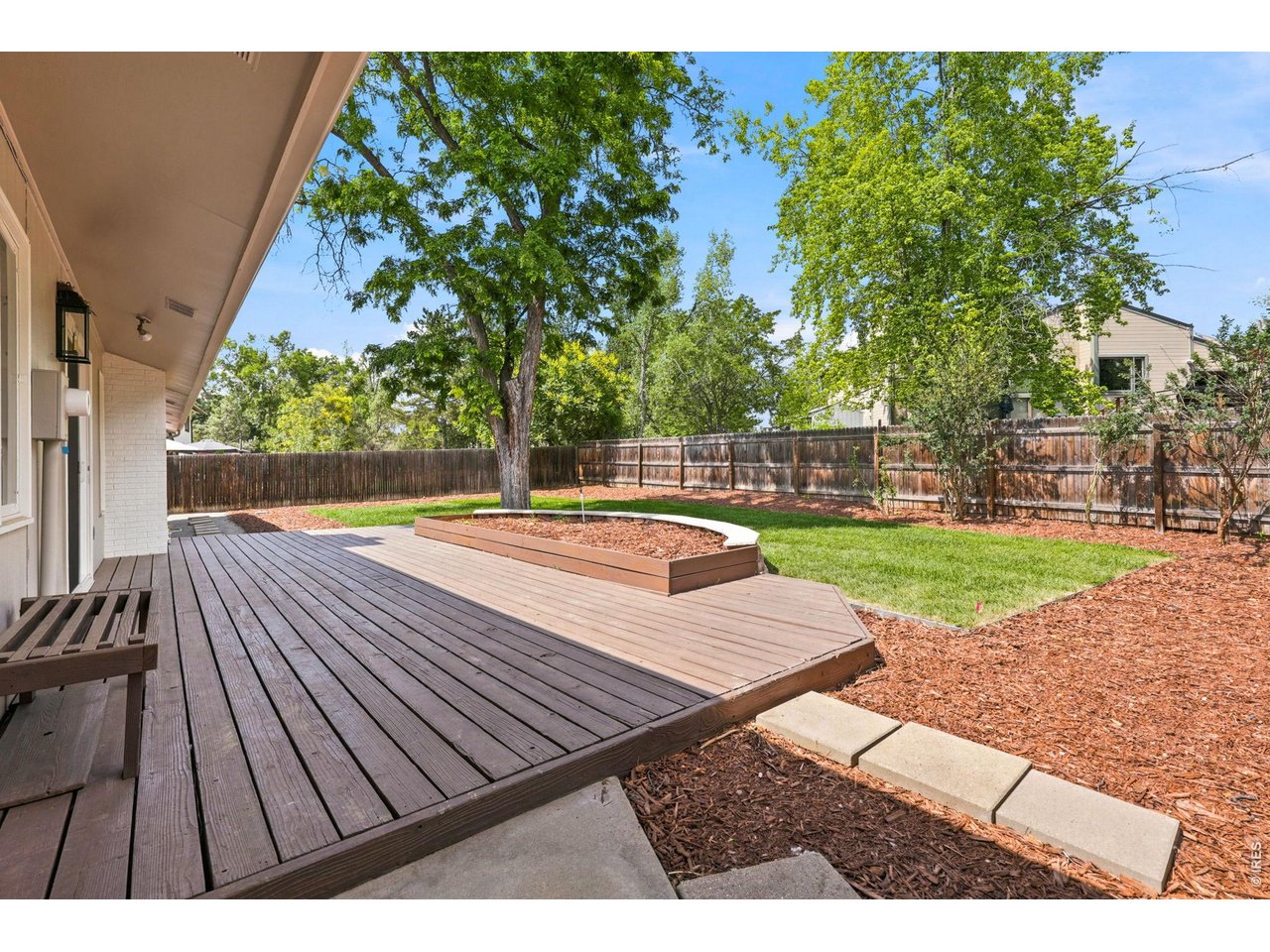4788 Briar Ridge Trail Boulder, CO 80301 - Photo 37 of 45 Spacious, fully fenced backyard featuring a large deck off the kitchen, new sod, fresh mulch, raised garden bed and a professional-grade sprinkler system.