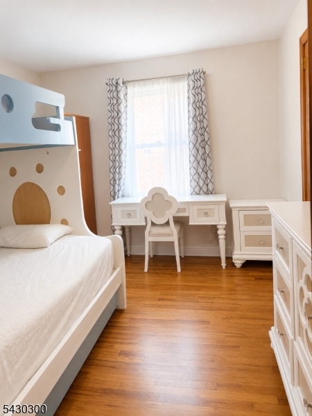 25 Spring Street, Unit A Millburn, NJ 07041 - Photo 14 of 21 a bedroom with a bed and a large window