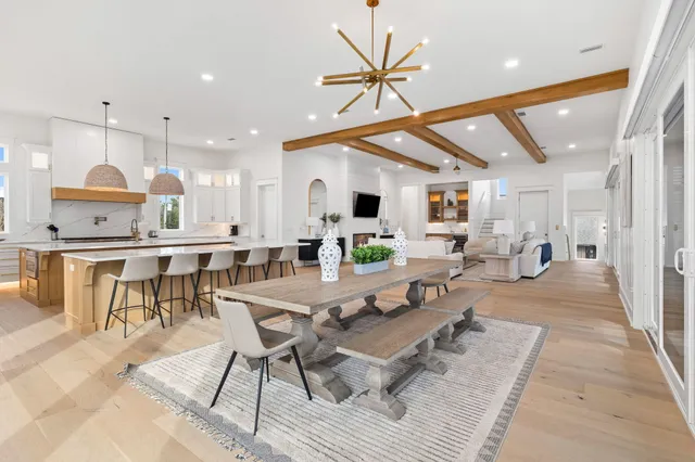 a living room with couches and a large mirror with wooden floor