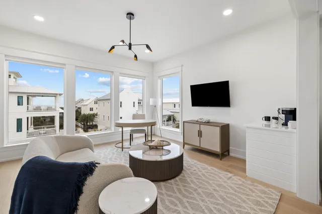 a bedroom with a large bed and a flat tv screen on dresser