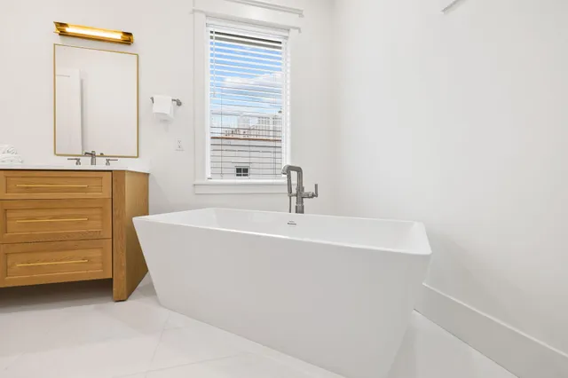a bathroom with a double vanity sink and a mirror