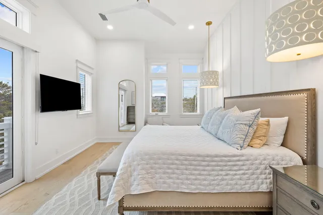 a bedroom with a large bed and a chandelier