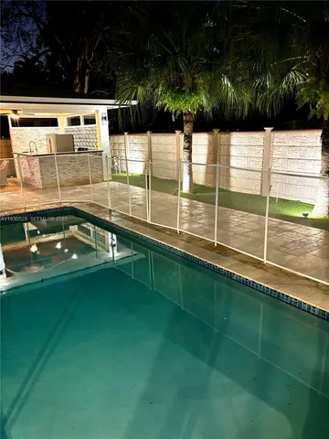 a view of swimming pool with seating area