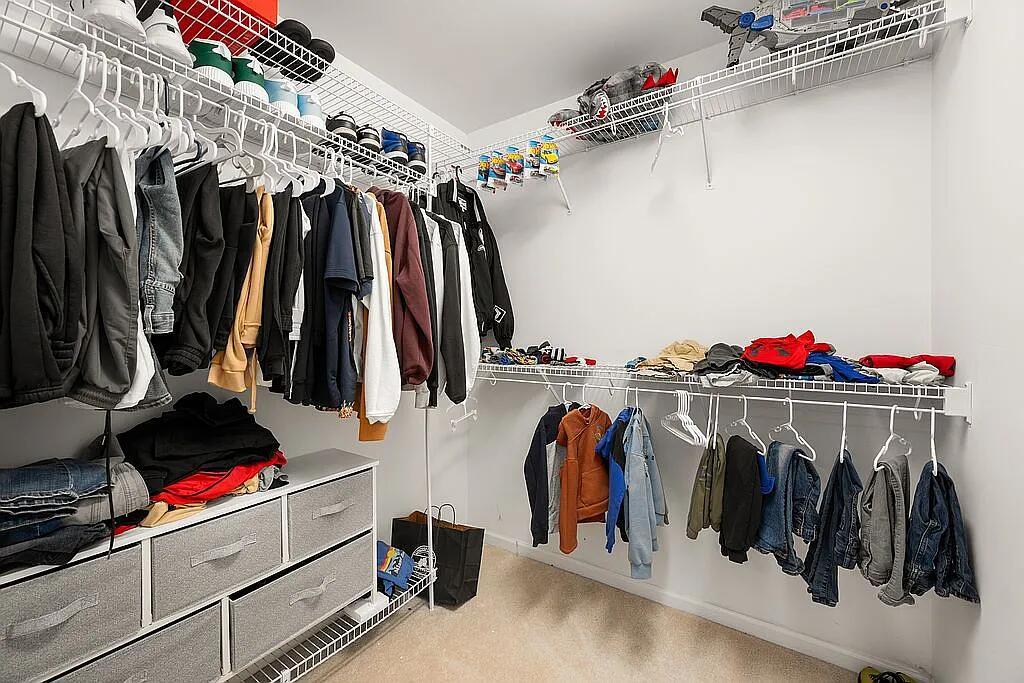 678 Elizabeth Street Maple Park, IL 60151 - Photo 13 of 18 a view of walk in closet with clothes and shoes