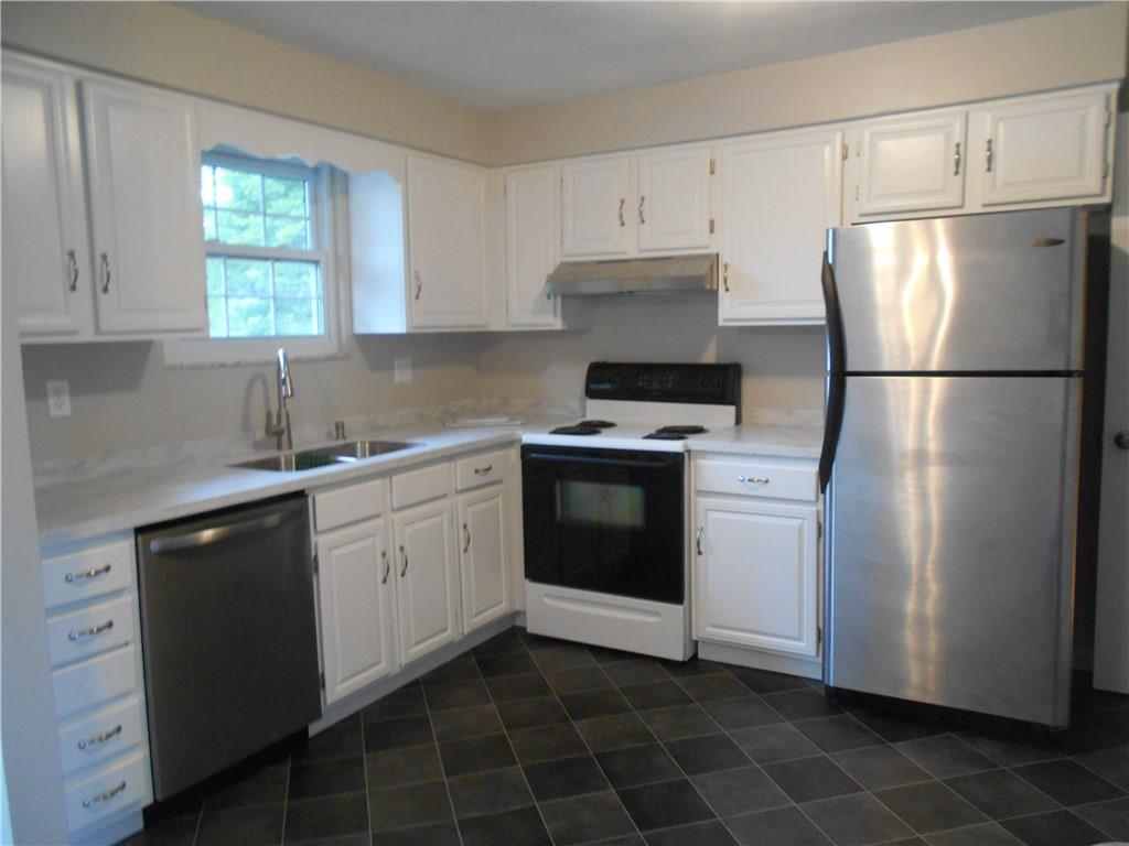 133 Singleton Road Sarver, PA 16055 - Photo 2 of 20 Nice and bright kitchen with new flooring and Corian countertops.