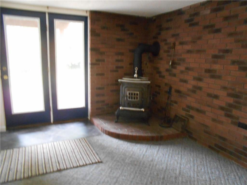 133 Singleton Road Sarver, PA 16055 - Photo 15 of 20 Wood burning stove in gameroom. Walk out to concrete patio to relax.