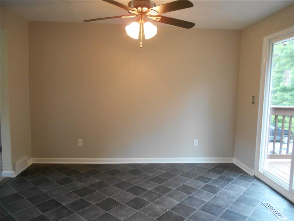 133 Singleton Road Sarver, PA 16055 - Photo 4 of 20 Dining area with new flooring and glass sliding door leads to a deck.
