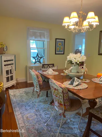 a dining room with furniture a rug and a chandelier