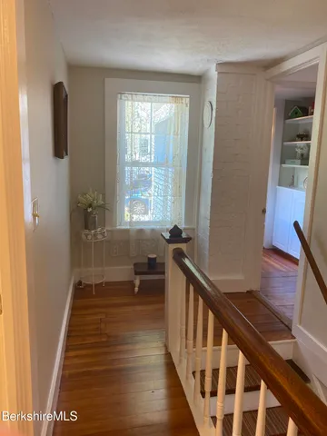 a view of an entryway with wooden floor