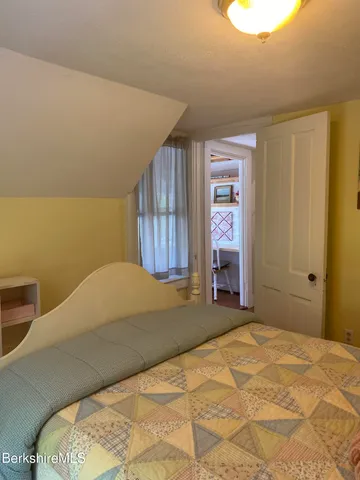 a bed room with a bed and a window