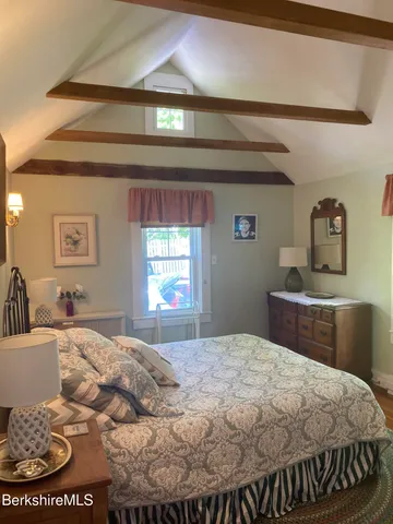 a bedroom with a bed and window