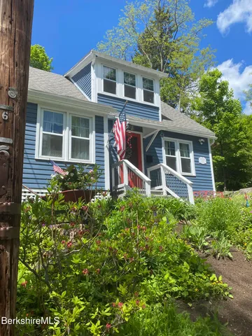 a front view of a house with yard