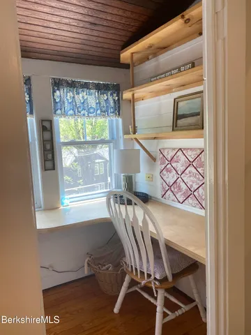 a room with wooden floor and a window