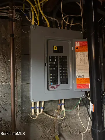 a view of a house with a small yard and flower plants