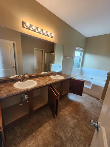 an empty room with windows and fireplace