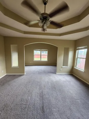 a living room with stainless steel appliances kitchen island granite countertop a stove a sink and a refrigerator