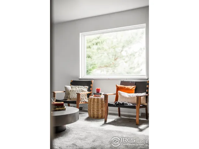 a reading room with furniture and window