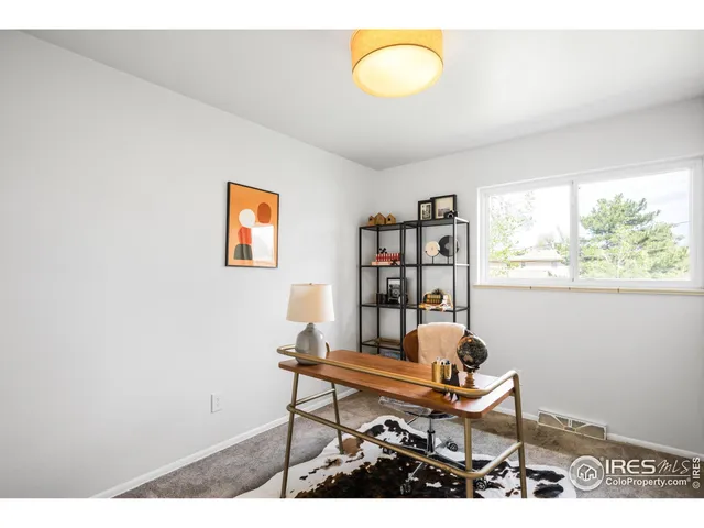 a work room with furniture and a window