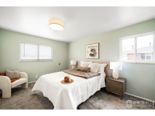 a bedroom with bed and a window