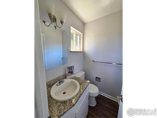 a bathroom with a sink and mirror with toilet