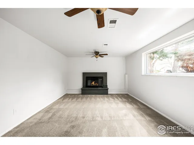 a view of an empty room with a fireplace