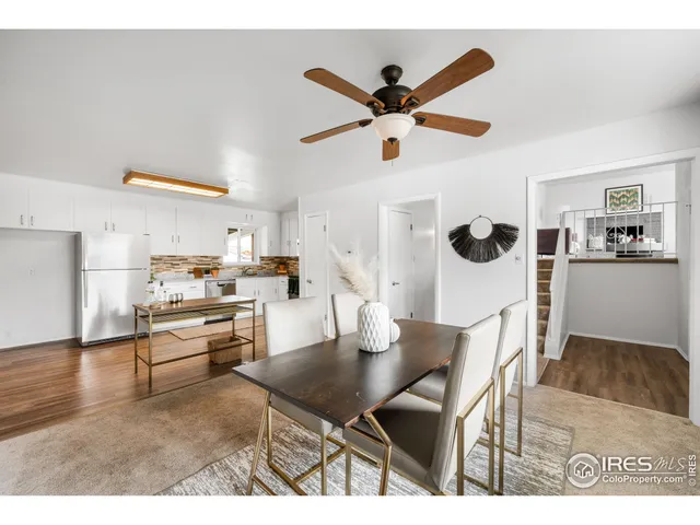 a living room with furniture and kitchen view