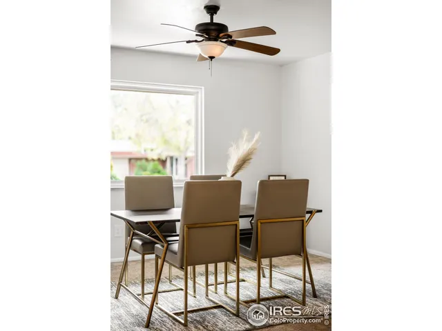 a dining room with furniture and a window