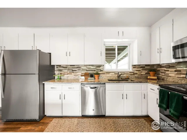 a kitchen with stainless steel appliances granite countertop a refrigerator sink and cabinets