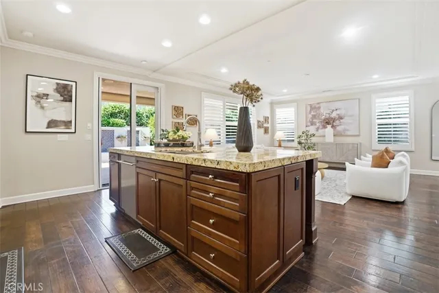 a kitchen with a sink stove and wooden floor