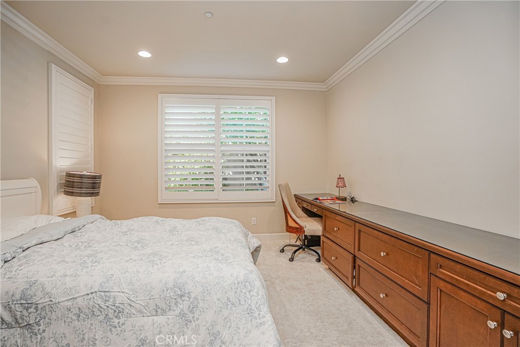 65 Rolling Green Irvine, CA 92620 - Photo 18 of 49 a bedroom with a bed and a table in it