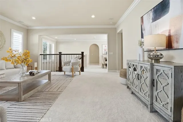 a spacious bedroom with a large bed and a chandelier