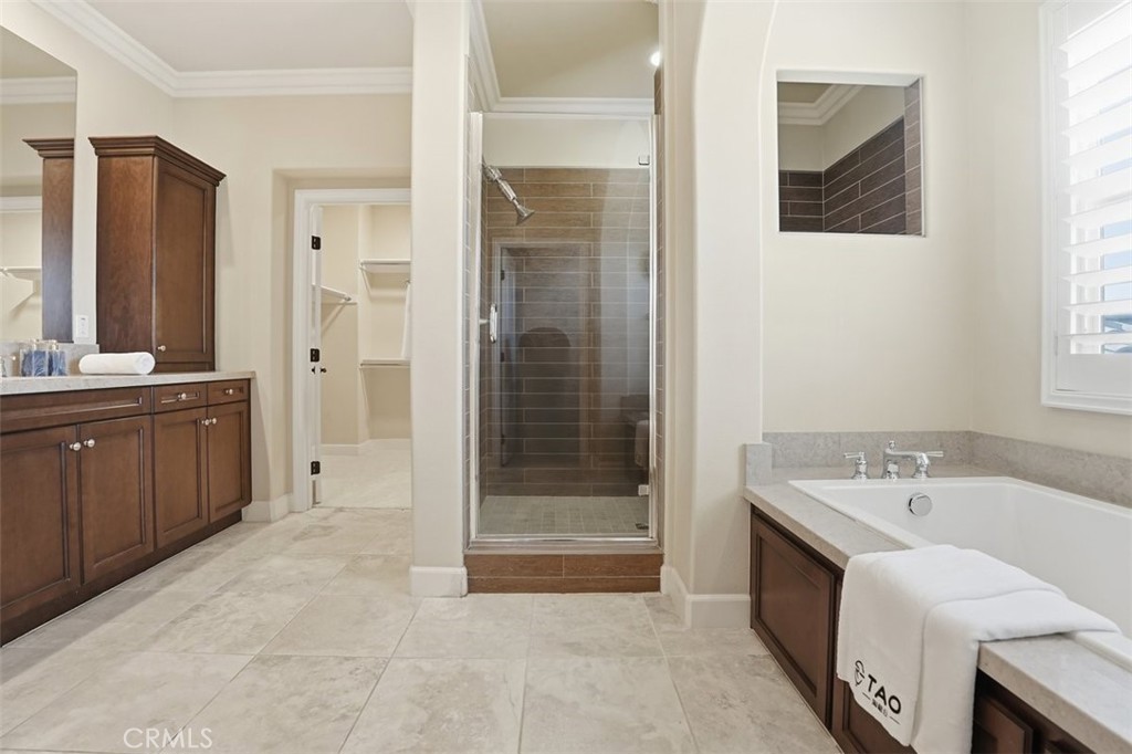 65 Rolling Green Irvine, CA 92620 - Photo 30 of 49 a bathroom with a tub sink and mirror