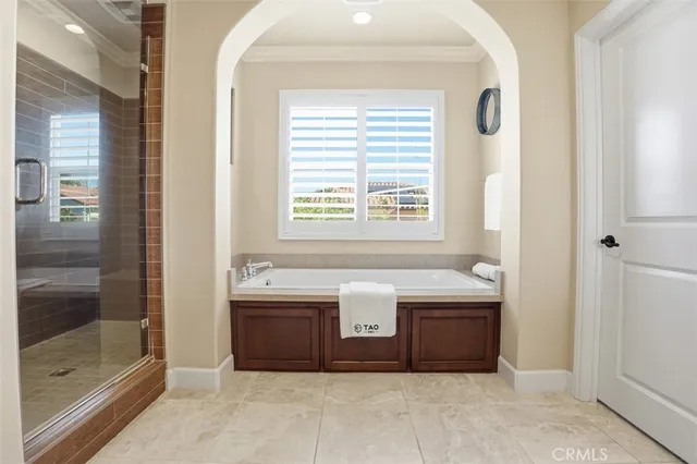 a spacious bathroom with double vanity and a bathtub