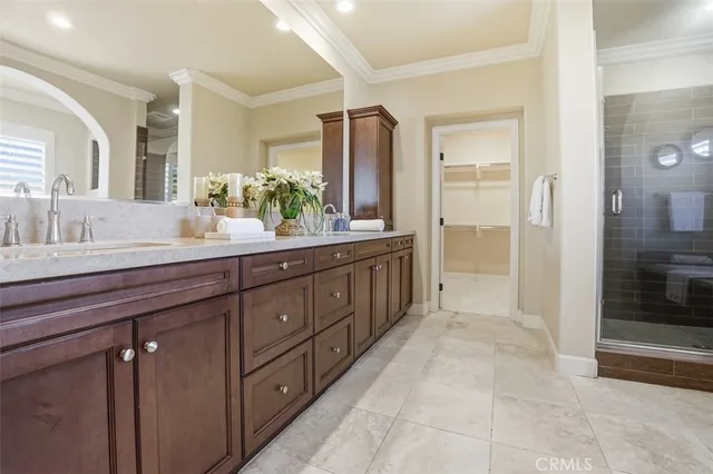 a spacious bathroom with a granite countertop sink mirror and shower