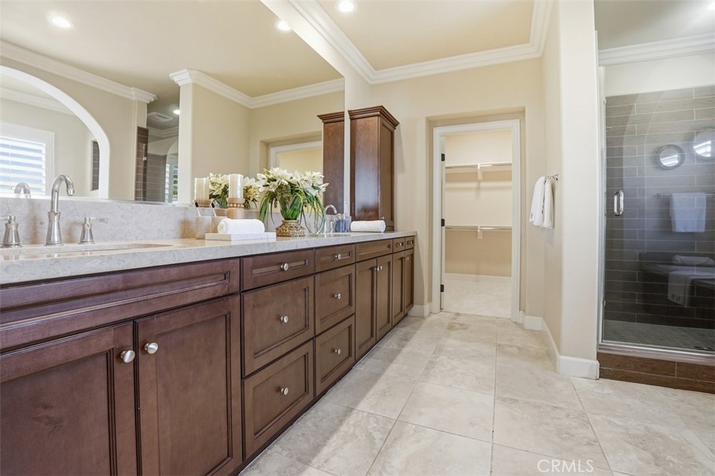 65 Rolling Green Irvine, CA 92620 - Photo 32 of 49 a spacious bathroom with a granite countertop sink mirror and shower