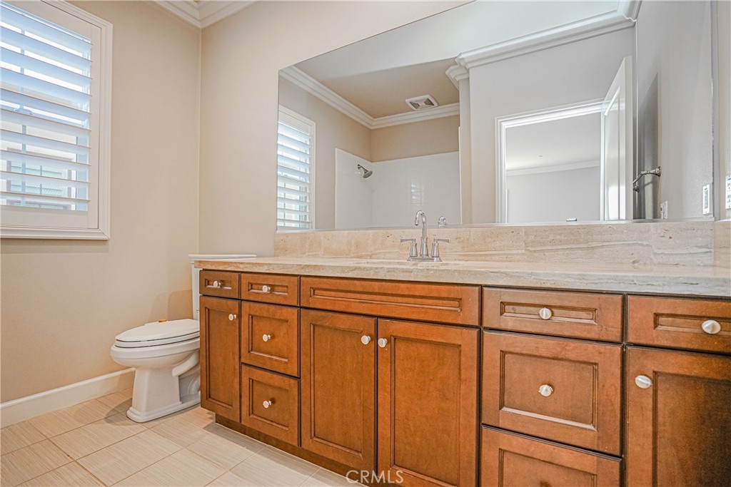 65 Rolling Green Irvine, CA 92620 - Photo 35 of 49 a bathroom with a double vanity sink a toilet and a mirror