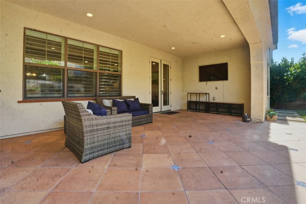 65 Rolling Green Irvine, CA 92620 - Photo 40 of 49 a living room with furniture and a flat screen tv