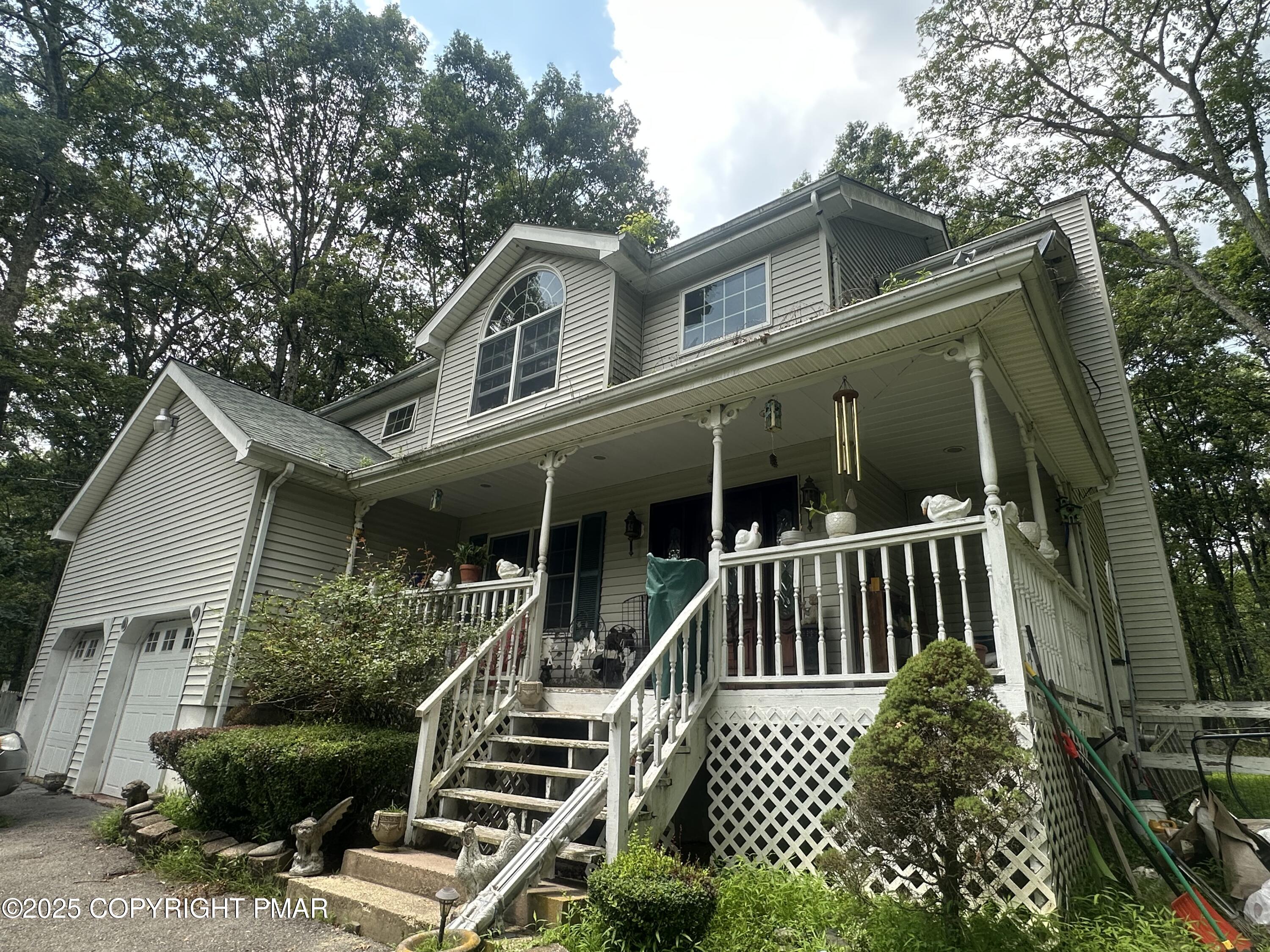 a view of house with a yard and potted plants