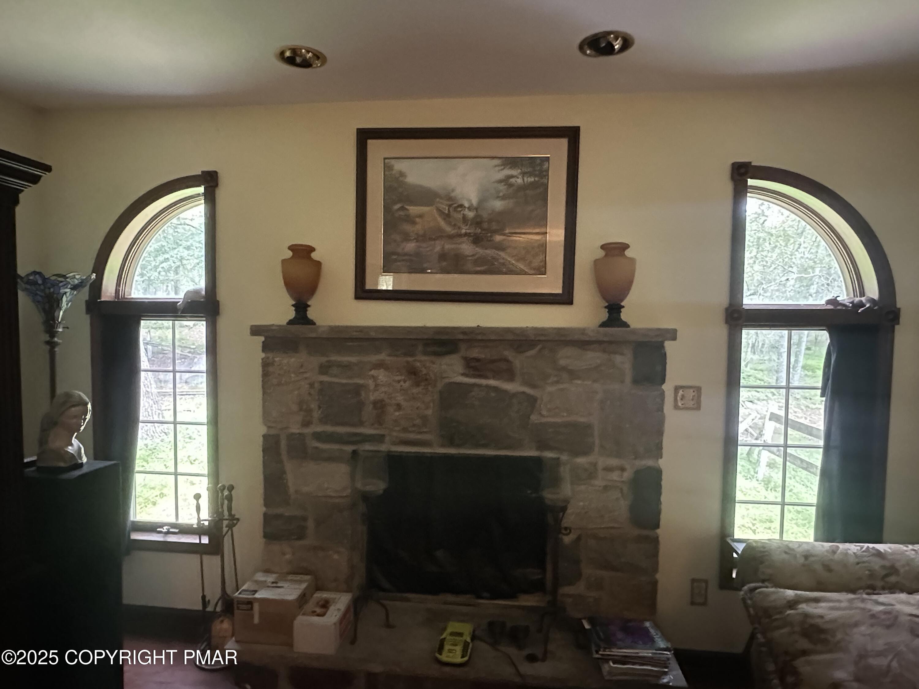 2162 Longview Drive Bushkill, PA 18324 - Photo 13 of 33 a living room with furniture a flat screen tv and a fireplace