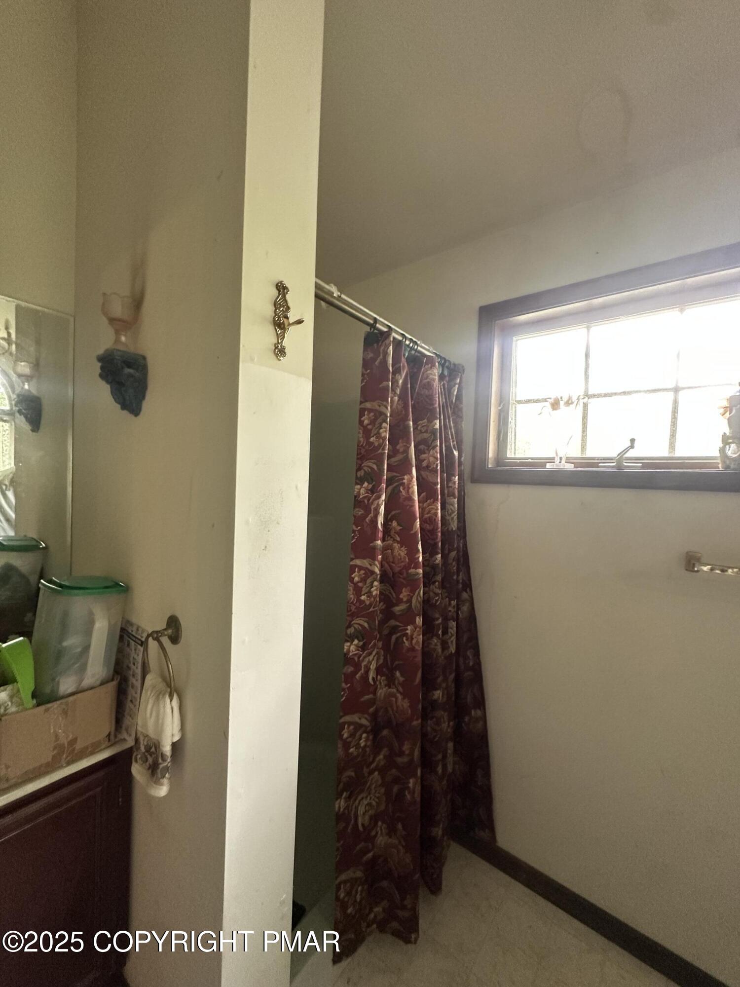 2162 Longview Drive Bushkill, PA 18324 - Photo 26 of 33 a bathroom with a shower curtain and a window