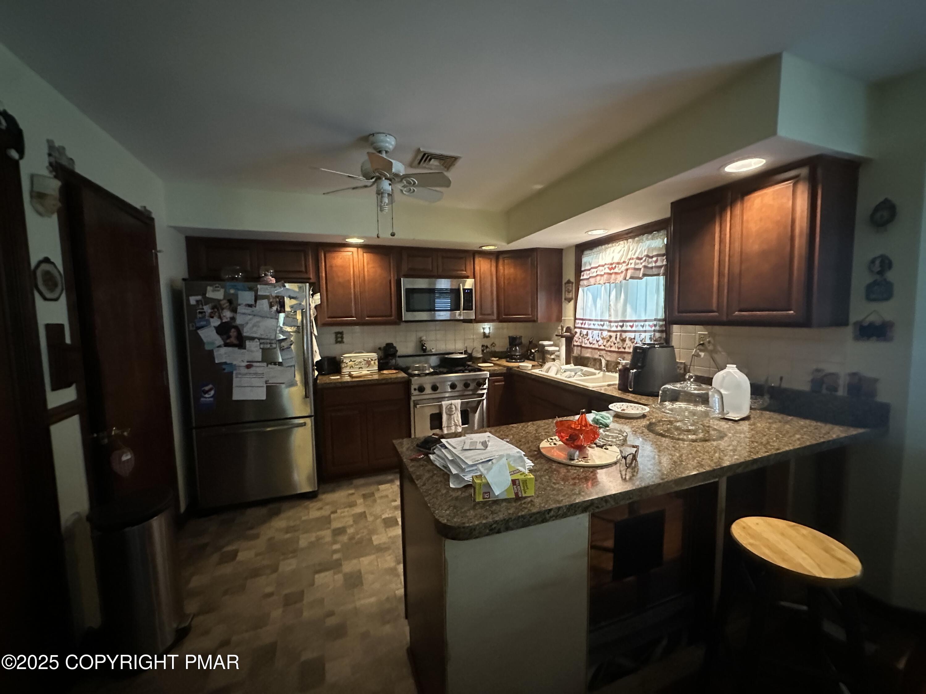 2162 Longview Drive Bushkill, PA 18324 - Photo 7 of 33 a kitchen with stainless steel appliances granite countertop a sink refrigerator and cabinets