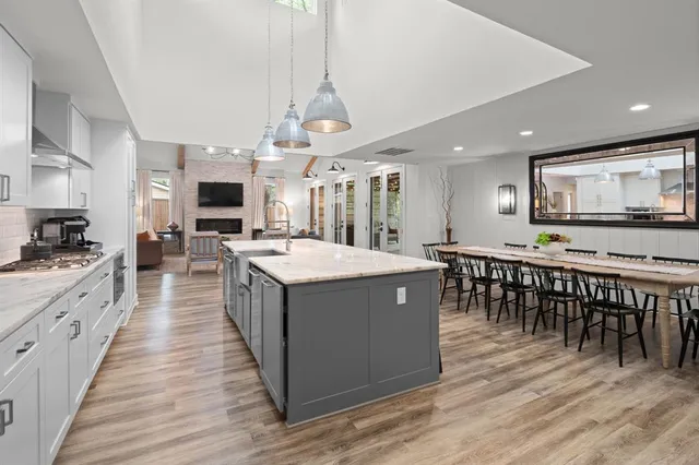 a kitchen with white cabinets and appliances