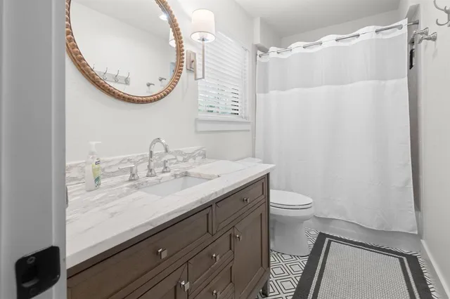 a bedroom with bed and a window