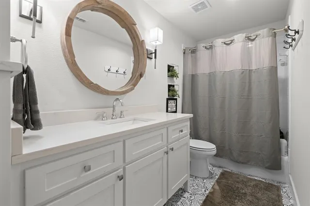 a bathroom with a shower sink and mirror