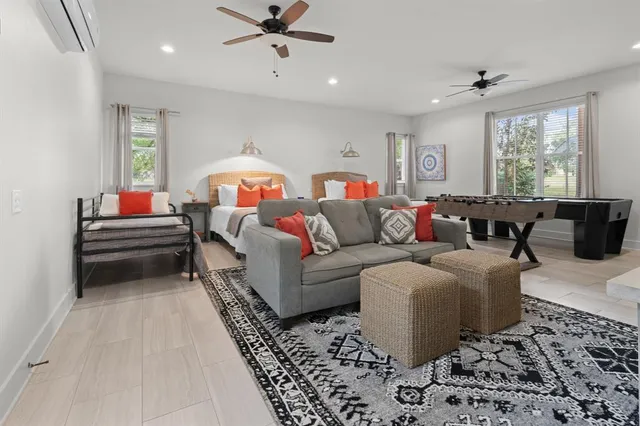 a bedroom with a bed a couch and a window