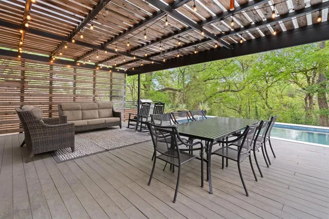 a view of a patio with table and chairs with wooden floor