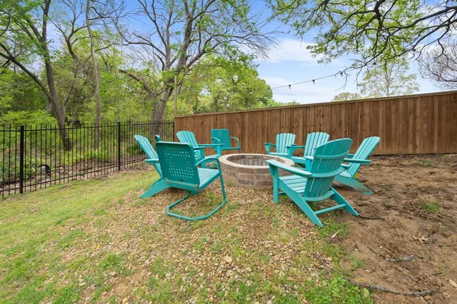 a backyard of a house with table and chairs