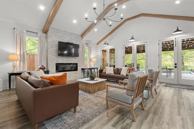 a large kitchen with stainless steel appliances kitchen island granite countertop a large counter top and wooden floors